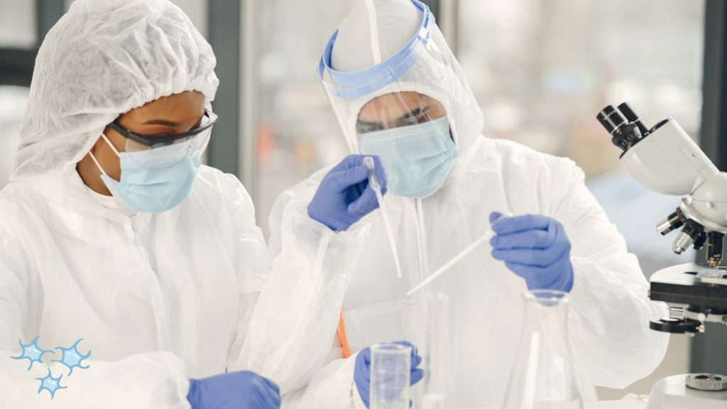 couple in the lab with a microscope nearby.