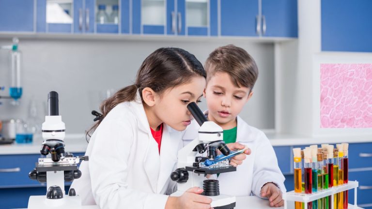 kids using a microscope in a lab.