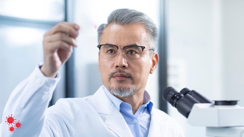 man looking at a prepared slide.