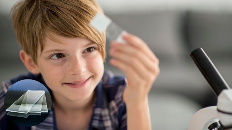 a boy with a microscope slide in his hand.